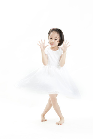 Girl posing in a white dressの写真素材