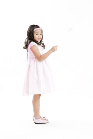 Girl posing as an angel dressed in a white dressの写真素材