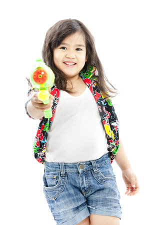 Girl holding a toy gun in casual clothingsの写真素材