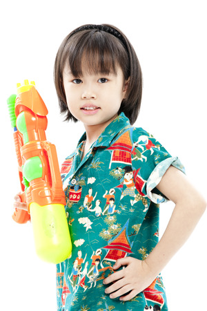 Girl holding a toy gun in casual clothingsの写真素材
