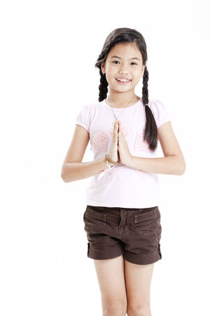 Girl posing with her hands placed togetherの写真素材