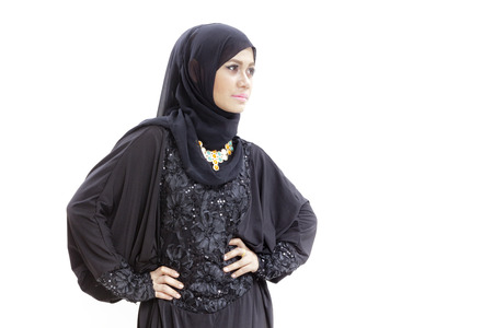 Woman wearing a hijab and dressed in malay attire with hands on hipの写真素材