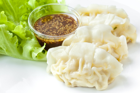 Dumplings with vegetables and sesame sauceの写真素材