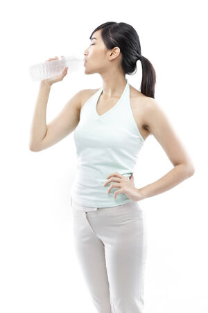 Young woman drinking water from a bottleの写真素材