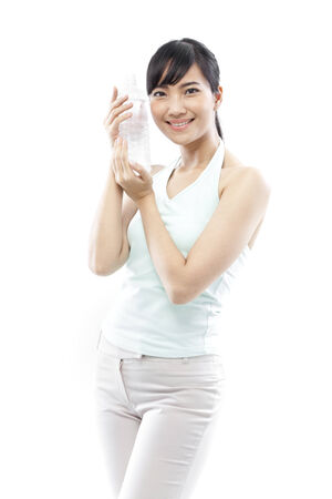 Young woman holding a bottle of waterの写真素材
