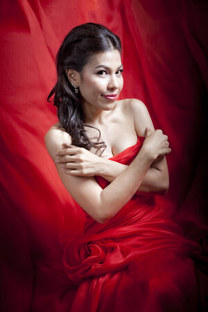 Woman posing in a red gownの写真素材