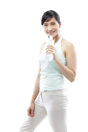 Young woman holding a bottle of waterの写真素材
