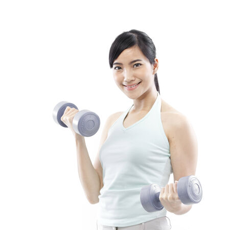 Young woman holding dumbbellsの写真素材