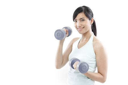 Young woman holding dumbbellsの写真素材