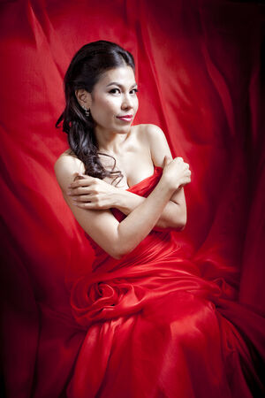 Woman posing in a red gownの写真素材