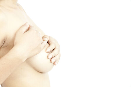 Side view of a woman covering her breastの写真素材