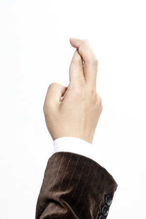 Businessman with fingers crossedの写真素材