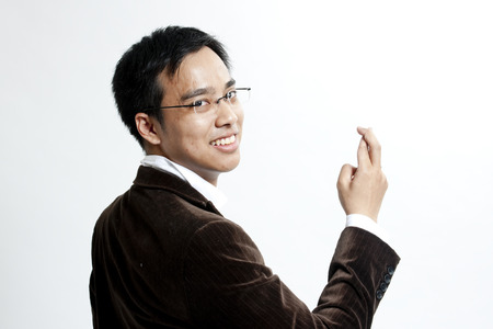 Businessman with fingers crossedの写真素材