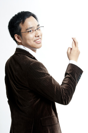 Businessman with fingers crossedの写真素材