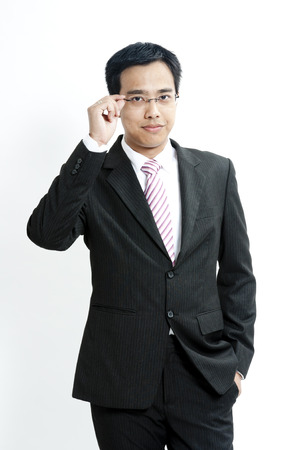 Businessman adjusting glassesの写真素材