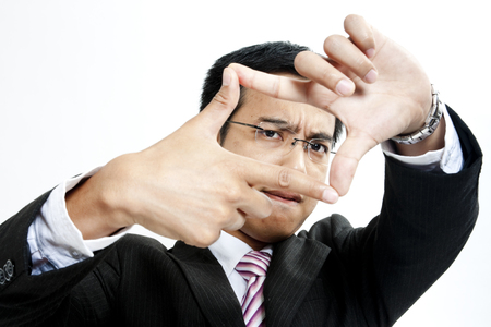 Businessman making a picture frame with his fingersの写真素材