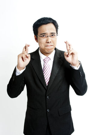 Businessman with fingers crossedの写真素材
