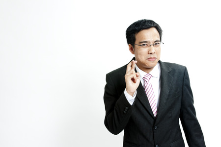 Businessman with fingers crossedの写真素材