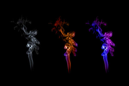 White smoke and colorful smoke on dark black backgroundの写真素材