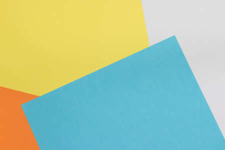 Colorful paper background on top view . (blue, white, yellow, orange)の写真素材