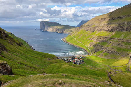 Small village of Tjornuvik, Faroe island in the sun seen from the hillの写真素材