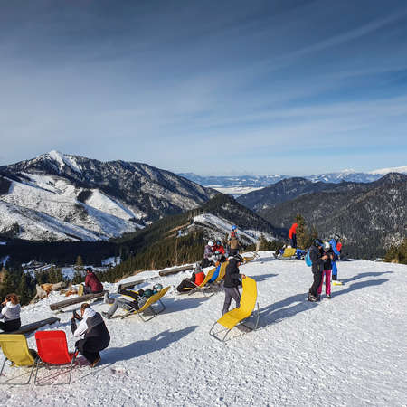Group of skiers taking a break and sunbathing on the slope of Chopok, Slovakia.のeditorial素材
