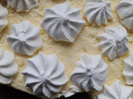 White meringue cake with whipped cream on top, close upの写真素材