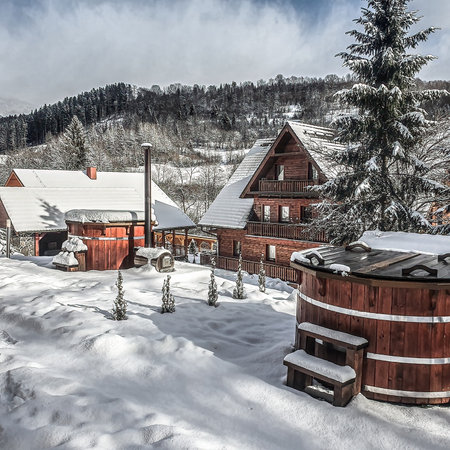 Wooden houses in the mountains covered with snow. Beautiful winter landscape.の写真素材