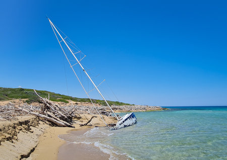 Sailing abandoned boat on the beach of the island of Sicily, Italyの写真素材