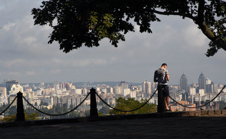 Young Ukrainian man and the panorama of Kiev, ukraineの写真素材