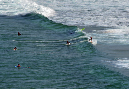 Surfers at the Algarve coast, Portugalの写真素材