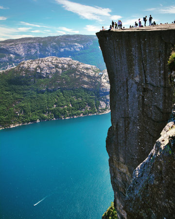 Tourists on the cliff above the fjord in Norway.の写真素材