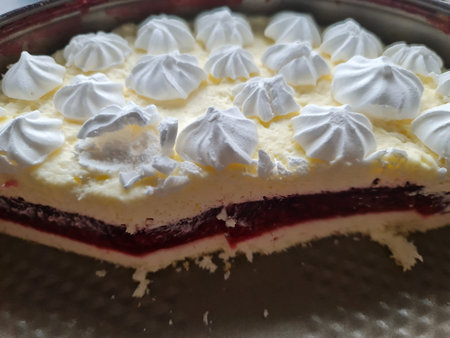 Piece of raspberry cake with whipped cream and meringue.の写真素材