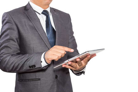 Man in suit, shirt and tie holding a tablet computerの写真素材