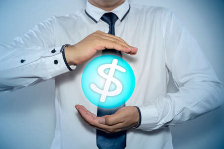 businessman protecting dollar symbolの写真素材