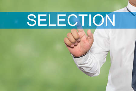 Businessman hand touching SELECTION tab on virtual screenの写真素材