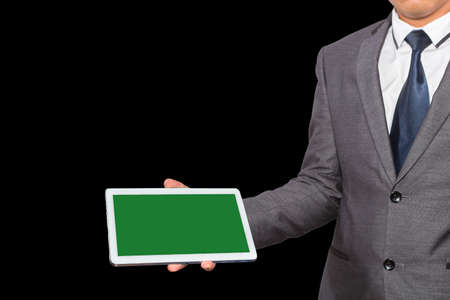 Man in suit, shirt and tie holding a tablet computerの写真素材
