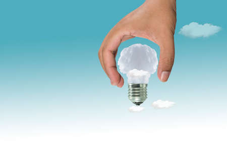 Lamp made of clouds in hand on sky. Ecology conception.Blue sky.