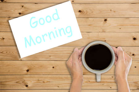 Good morning coffee cup top view on wooden table backgroundの写真素材