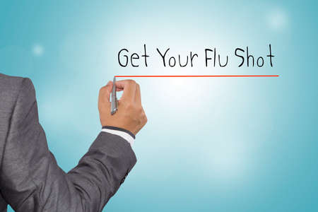 Businessman writing Get Your Flu Shot with pen on visual screen. Business, technology, internet concept.の写真素材