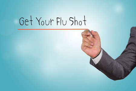 Businessman writing Get Your Flu Shot with pen on visual screen. Business, technology, internet concept.の写真素材