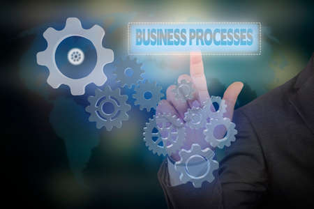 Businessman pressing touch screen interface and select icon "BUSINESS PROCESSES" on virtual screen. Internet concept. Business concept. Business idea , strategy conceptの写真素材