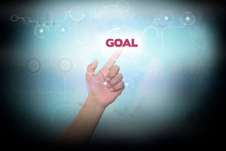 Businessman pressing button on touch screen interface and select GOAL. Business conceptの写真素材