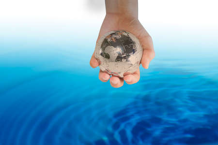Planet in human hands on blurred beautiful nature background. Investment, Ecology, World Environment...