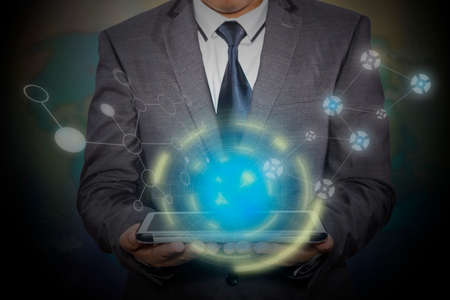 Businessman hand working with modern technology digital tablet computer and digital layer effect as business strategy conceptの写真素材