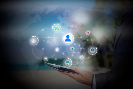 businessman holding a tablet PC with contact on virtual screens - business, technology, internet and social networking conceptの写真素材
