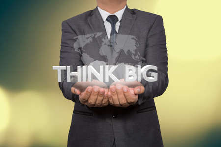 businessman holding with think big sign 3d,think big concept wordsの写真素材