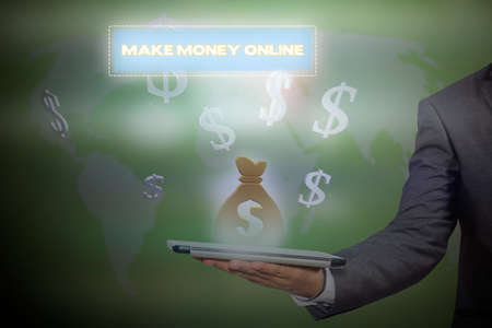 businessman holding a tablet PC with the make money button. business concept. Internet concept. Make Money Onlineの写真素材