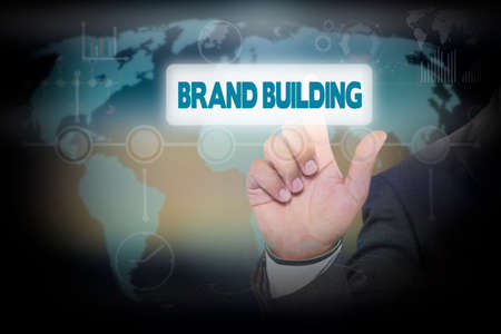 Businessman pressing button on touch screen interface and select BRAND BUILDING. Business conceptの写真素材