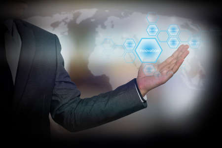 Businessman holding  icon with Innovation words on the screen. business concept.の写真素材